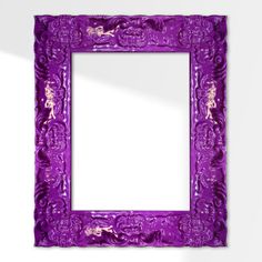 a purple frame with an ornate design on the top and bottom, in front of a white wall