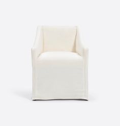 a white chair sitting on top of a white floor