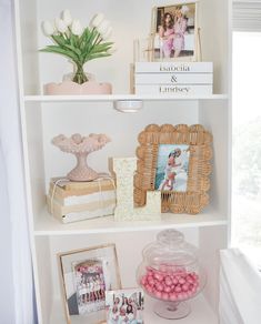 a shelf filled with pictures and candies on top of it