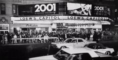 an old black and white photo of some cars in front of a drive - in