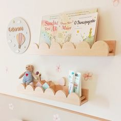 two wooden shelves with books and toys on them