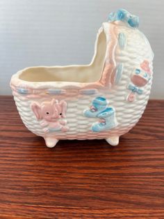 a ceramic baby's pram on a wooden table