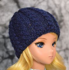 "Just fine for any kind of weather, each of these hats will keep your doll warm and cover up on bad hair days while being fashionable. Hand-knit in our studio, some are OOAK. Choose from the selection of solid colors. Modeled on Smart Dolls, a 24\" doll with an 8-9\" head. If they are Merino wool or wool, it will say so in the variation. If it does not say wool, then it isn't. We have a lot of fibers and colors to work with and we know some of our customers are allergic to wool, so we try to mix One Size Knitted Beanie Mini Hats, Knitted Mini Beanie Hat, Knitted One Size Mini Cap, One Size Knitted Mini Cap, Hand Knitted Beanie Mini Hat, Wool Hat Knit, Wool Caps, Doll Hat, Smart Doll