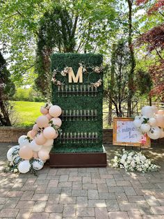 a table with balloons, flowers and candles on it in front of a sign that says m