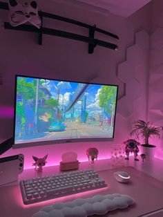 a desk with a computer monitor, keyboard and mouse on it in front of a pink background