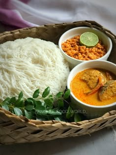 two bowls filled with food sitting on top of a table next to rice and vegetables