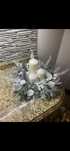 a candle and some white flowers on a counter