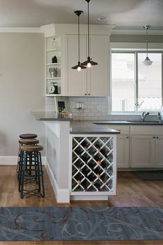 a kitchen with white cabinets and bar stools