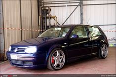 a blue car is parked in a garage