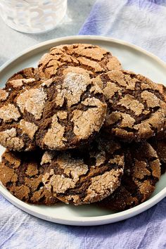 a white plate topped with cookies covered in powdered sugar on top of a table