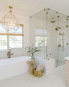 a bathroom with a tub, shower and sink