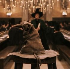 a wizard's hat sitting on top of a wooden stool in a dining room