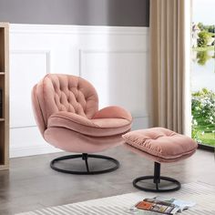 a pink chair and ottoman in a living room