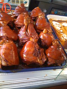 there are many cooked meats in the tray on the counter top, ready to be eaten