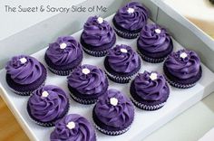 twelve purple cupcakes in a white box with the words sweet & savory side of me