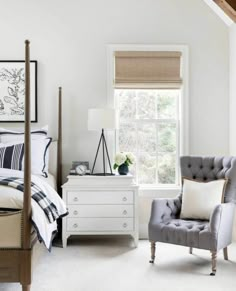 a bedroom with white walls and furniture