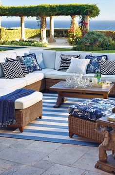 an outdoor living room with blue and white pillows