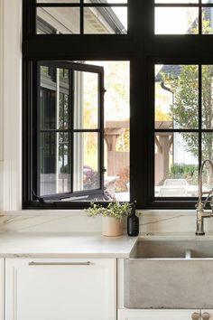 Kitchen with windows above the sink Black Kitchen Windows Above Sink, Windows Above Sink, Kitchen Windows Above Sink, Window Above Sink, Cape Kitchen, Andersen Doors, Windows Black, Spec House, Kitchen Traditional