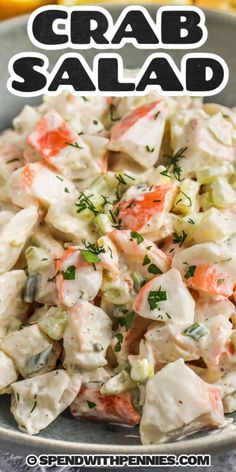 crab salad with carrots and celery in a bowl on top of a table