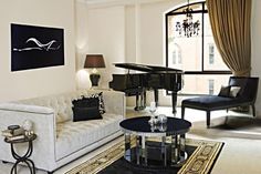 a living room filled with furniture and a piano