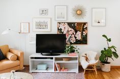 a living room filled with furniture and pictures on the wall above it is a flat screen tv