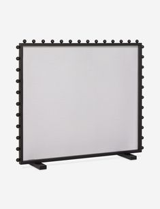 a white screen with black studding on the sides and an iron frame around it