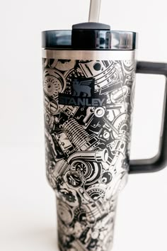 a black and white photo of a travel mug