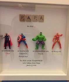 a white frame with four different avengers figurines in it