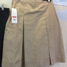 Knee-Length Traditional Twill Khaki Girl's Uniform Skirt With Front And Back Pleats, Side-Zip Closure, Inseam Pocket On Wearer's Right, And 2-Inch Hem For Lengthening. Adjustable Waist Band. From Classroomuniforms.Com Https://Online.Flippingbook.Com/View/854576516/16-17/ Both Style 55729a, Size 14. Made Of 65% Poly/35% Cotton. Office Workouts, Kick Pleat Skirt, Inseam Pocket, White Polka Dot Skirt, Uniform Skirt, Halloween Skirt, Christmas Skirt, Pleat Skirt, Purple Halloween