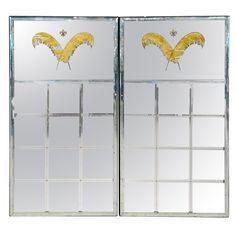 two mirrors with yellow feathers on them