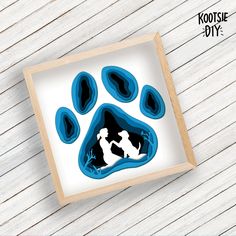 an image of a dog's paw print in a frame on a wooden table