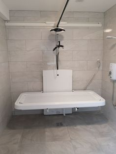 a bathroom with a white toilet and shower head