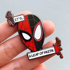 a spiderman pin with the words it's a leap of faith