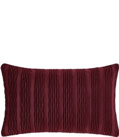 a red pillow with pleated fabric on it