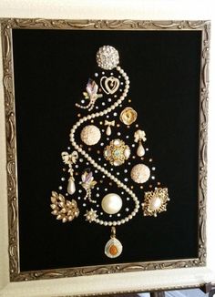 a christmas tree made out of pearls and other ornaments on a black background with gold trim