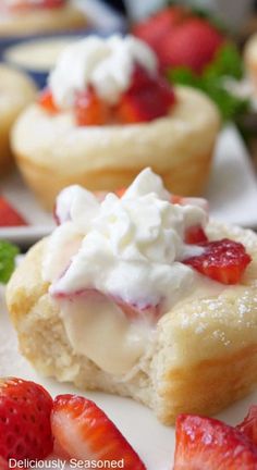 strawberry shortcakes with whipped cream and fresh strawberries on the side are ready to be eaten