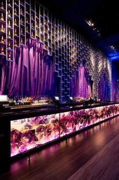 the bar is decorated with purple curtains and lights