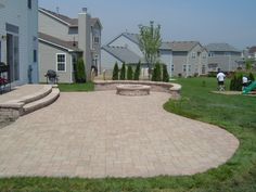 a brick patio with steps leading to the back yard