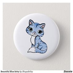 a button with a cartoon cat sitting on it's side and eyes wide open