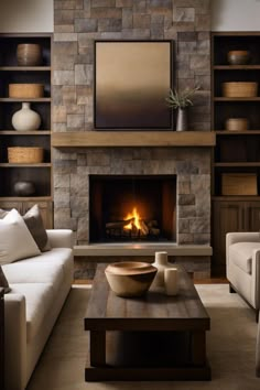 a living room filled with furniture and a fire place in the middle of a fireplace