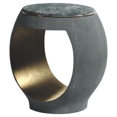 a grey and gold stool with a cushion on the top that is shaped like a circle