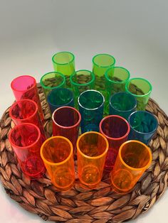 many different colored glasses are sitting in a basket