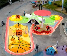 an aerial view of children's play area with colorful playground equipment and people walking around