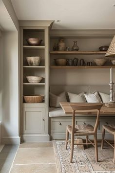 a table and chairs in a room with shelves