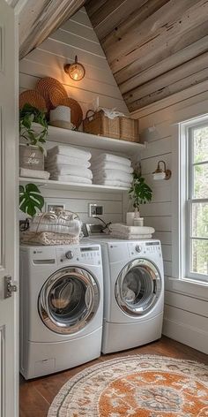 a washer and dryer in a room with wooden floors, white walls and ceiling