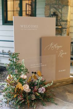 the welcome sign and flowers are on display