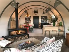 a living room filled with furniture and a fire place in the middle of an archway