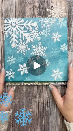 someone is making a snowflake card with their hands