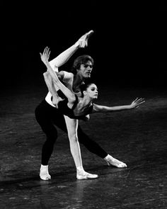 two ballerinas in black and white pose for the camera