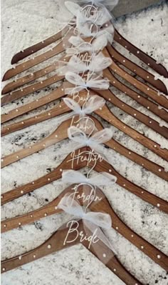 wooden clothes hangers with personalized names and bows on them in the shape of hearts